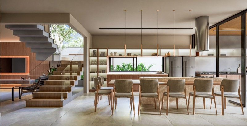 Cozinha integrada à sala de jantar com ilha em pedra e escada escultural em projeto residencial de alto padrão